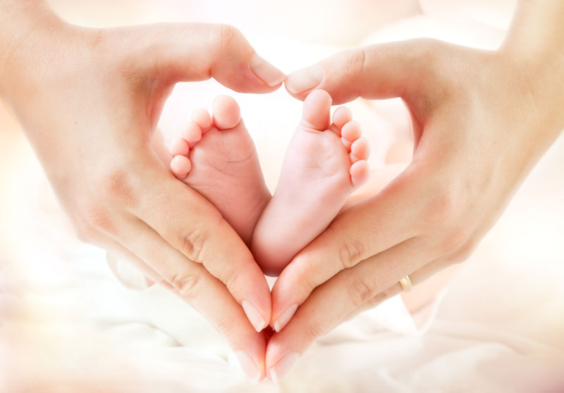 mother holding baby's feet