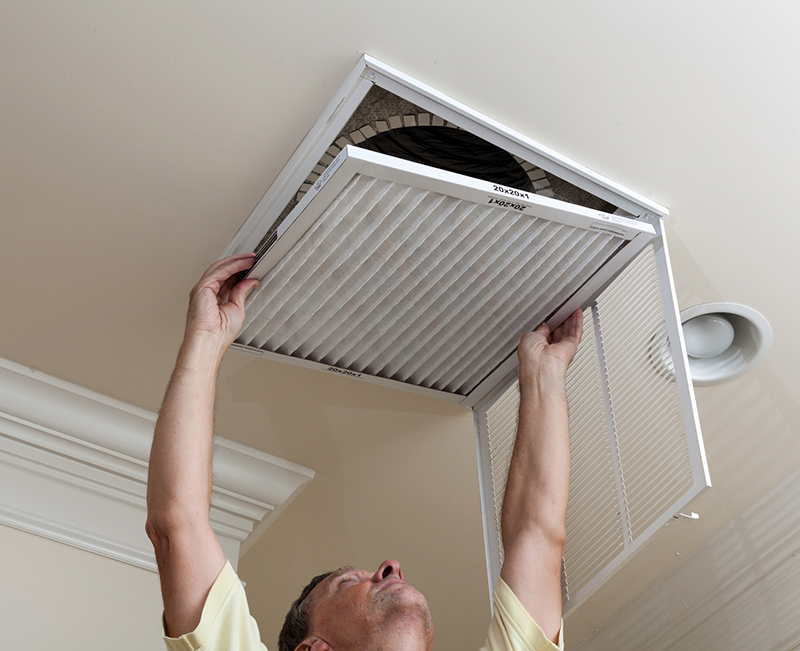 man replacing an air filter