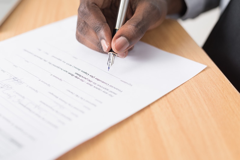 a man signing a document